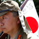 Men dressed as Japanese imperial army soldiers march in front of the gate of the Yasukuni Shrine in Tokyo August 15, 2014, to mark the 69th anniversary of Japan's surrender in World War Two.